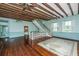 Large living area with hardwood floors, exposed beams, and a staircase at 8083 Point Of Pines Rd, Edisto Island, SC 29438