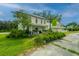 Building exterior, featuring a porch and landscaping at 8083 Point Of Pines Rd, Edisto Island, SC 29438