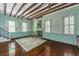 Spacious living room featuring hardwood floors, exposed beams, and a fireplace at 8083 Point Of Pines Rd, Edisto Island, SC 29438