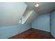 Simple attic bedroom with wood floors and sloped ceilings at 8083 Point Of Pines Rd, Edisto Island, SC 29438