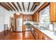 Kitchen with wood cabinets, stainless steel appliances, exposed beams, hardwood floors at 8083 Point Of Pines Rd, Edisto Island, SC 29438