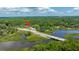 Aerial view showing a house near a bridge and water at 8083 Point Of Pines Rd, Edisto Island, SC 29438
