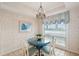 Bright dining area with round table and four chairs, near a window at 4405 Ocean Clb, Isle of Palms, SC 29451