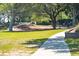 Paved walkway winds through a lush green space with picnic tables at 4405 Ocean Clb, Isle of Palms, SC 29451