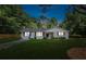 Charming white ranch home with black shutters and landscaping at 1555 Scott Hill Rd, Charleston, SC 29412