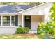 Front entrance of a brick home with a dark door and landscaping at 1555 Scott Hill Rd, Charleston, SC 29412