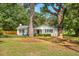 Ranch home nestled among tall trees with a spacious yard at 1555 Scott Hill Rd, Charleston, SC 29412