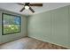 Bright bedroom with wood-look flooring, ceiling fan, and large window at 137 Thelma Dr, Summerville, SC 29485