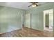 Bedroom with wood-look floors, ceiling fan, and access to bathroom at 137 Thelma Dr, Summerville, SC 29485