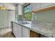 Kitchen boasts granite countertops and white cabinetry at 137 Thelma Dr, Summerville, SC 29485