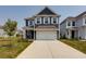 Two-story dark blue house with white garage door and driveway at 427 Grove End Rd, Moncks Corner, SC 29461