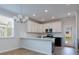 Eat-in kitchen with white cabinets, island, and access to backyard at 427 Grove End Rd, Moncks Corner, SC 29461