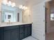 Double vanity bathroom with dark blue cabinets and gold accents at 427 Grove End Rd, Moncks Corner, SC 29461