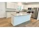 Modern kitchen with white cabinets, granite counters, and an island at 102 Whitesville Rd, Moncks Corner, SC 29461