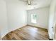 Well-lit bedroom with wood-look flooring and a window at 102 Whitesville Rd, Moncks Corner, SC 29461