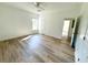 Bright bedroom featuring wood-look floors and an open door to another room at 102 Whitesville Rd, Moncks Corner, SC 29461