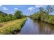 Serene waterway view with lush green banks at 210 Oyster Catcher Ln, Ravenel, SC 29470