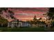 Multi-house community at sunset, featuring a large white home at 210 Oyster Catcher Ln, Ravenel, SC 29470