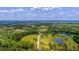Aerial view of property showcasing expansive land and ponds at 210 Oyster Catcher Ln, Ravenel, SC 29470