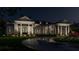 White house exterior at night with landscaping and driveway at 210 Oyster Catcher Ln, Ravenel, SC 29470