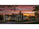 Two-story home exterior at sunset with landscaping at 210 Oyster Catcher Ln, Ravenel, SC 29470