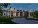White farmhouse with a metal roof, screened porch, and landscaping at 210 Oyster Catcher Ln, Ravenel, SC 29470
