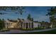 White farmhouse with a metal roof, screened porch, and landscaping at 210 Oyster Catcher Ln, Ravenel, SC 29470