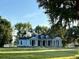 Stunning white farmhouse with a metal roof and a spacious porch at 210 Oyster Catcher Ln, Ravenel, SC 29470