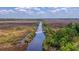 Aerial view of waterfront property with marsh and a tranquil waterway at 210 Oyster Catcher Ln, Ravenel, SC 29470