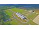 Aerial view of equestrian property showcasing barn, paddocks, and riding areas at 210 Oyster Catcher Ln, Ravenel, SC 29470