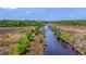 Drone view showing a tranquil waterway winding through a natural landscape at 210 Oyster Catcher Ln, Ravenel, SC 29470