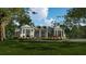 Elegant white farmhouse with a metal roof and circular driveway at 210 Oyster Catcher Ln, Ravenel, SC 29470