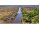 Aerial view of waterfront property with marsh and a tranquil waterway at 210 Oyster Catcher Ln, Ravenel, SC 29470