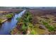 Aerial view of property with waterfront access and lush greenery at 210 Oyster Catcher Ln, Ravenel, SC 29470