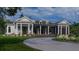 White house with a large front porch and landscaped yard at 210 Oyster Catcher Ln, Ravenel, SC 29470