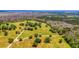 Aerial view of expansive property with lush green pastures, mature trees, and a tranquil pond at 210 Oyster Catcher Ln, Ravenel, SC 29470