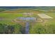 Aerial view of expansive equestrian facility with large barn and arenas at 210 Oyster Catcher Ln, Ravenel, SC 29470