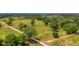 Aerial view of a property with a large pasture and split rail fencing at 210 Oyster Catcher Ln, Ravenel, SC 29470