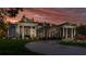 House exterior at sunset with landscaping and driveway at 210 Oyster Catcher Ln, Ravenel, SC 29470