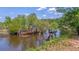 Overgrown waterfront with remains of an old dock at 210 Oyster Catcher Ln, Ravenel, SC 29470