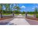 Brick pillars and gate entrance leading to a private community at 210 Oyster Catcher Ln, Ravenel, SC 29470