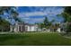 White house with large porch and landscaping, daytime view at 210 Oyster Catcher Ln, Ravenel, SC 29470
