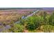 Aerial view of waterfront property with marsh and a tranquil waterway at 210 Oyster Catcher Ln, Ravenel, SC 29470