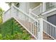 Brick steps with white railing leading to the home's entrance, lush greenery at 1602 Bernier Commons, Johns Island, SC 29455