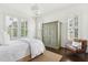 Bedroom with a queen bed, antique wardrobe, and natural light at 1602 Bernier Commons, Johns Island, SC 29455