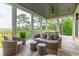 Spacious covered porch features wicker furniture and tranquil marsh views at 1602 Bernier Commons, Johns Island, SC 29455