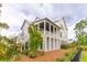 Three-story home with covered porch and landscaped yard at 1602 Bernier Commons, Johns Island, SC 29455