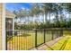 Private backyard with a black metal fence and lush green lawn at 386 Tupelo Lake Dr, Summerville, SC 29486