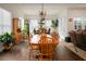 Sunlit dining room with hardwood floors, large table, and access to the kitchen and living room at 386 Tupelo Lake Dr, Summerville, SC 29486