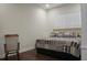 Comfortable bedroom with a king-size bed, rocking chair, and wood floors at 386 Tupelo Lake Dr, Summerville, SC 29486